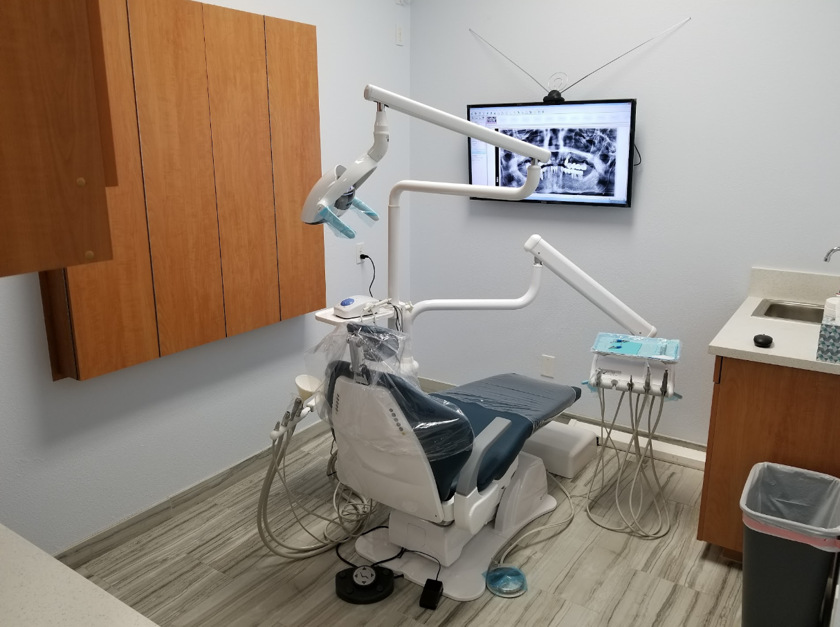Prime Dental treatment room with dental chair and imaging monitor