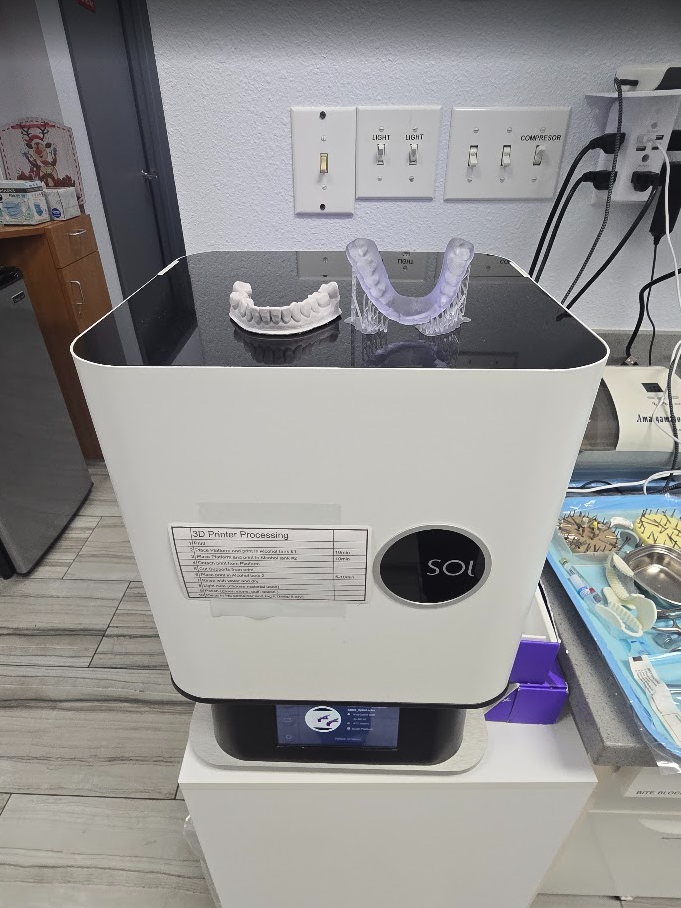 Our dental 3D printer with a study model and dental appliance